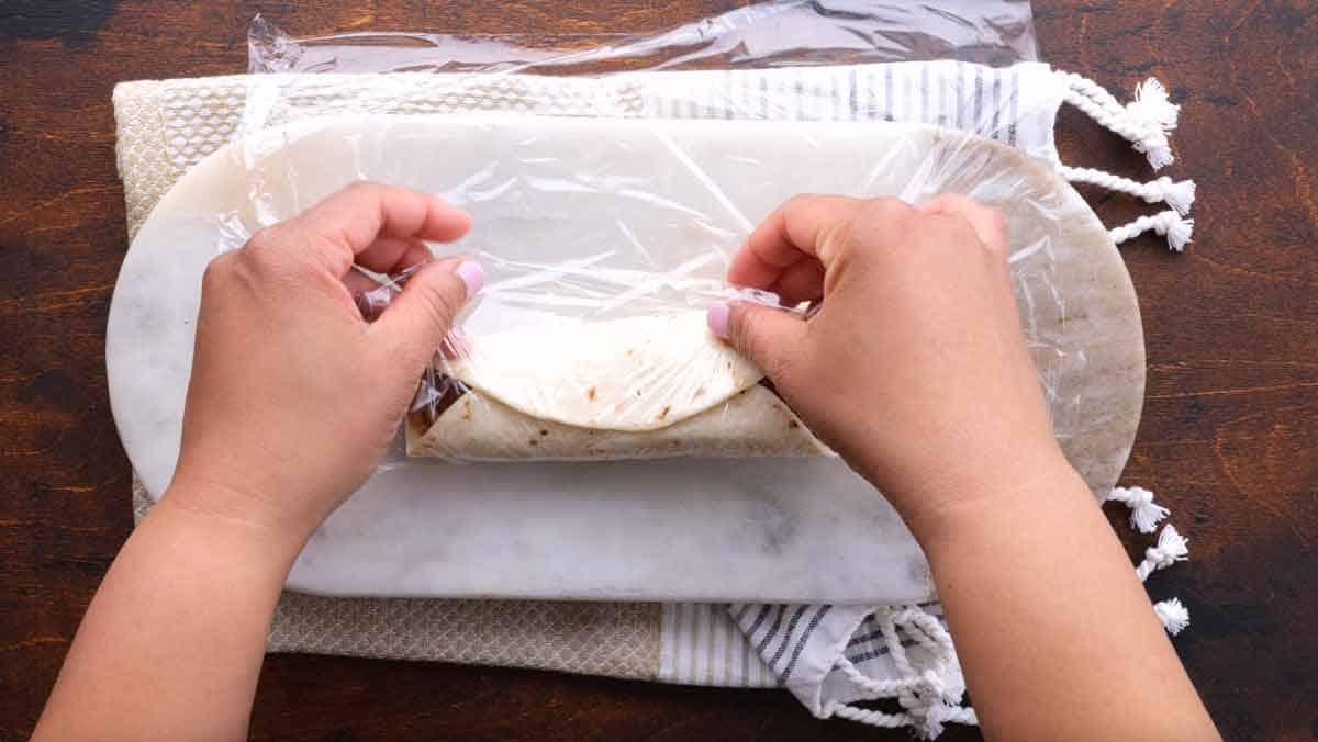 Wrapping burrito in plastic wrap to freeze
