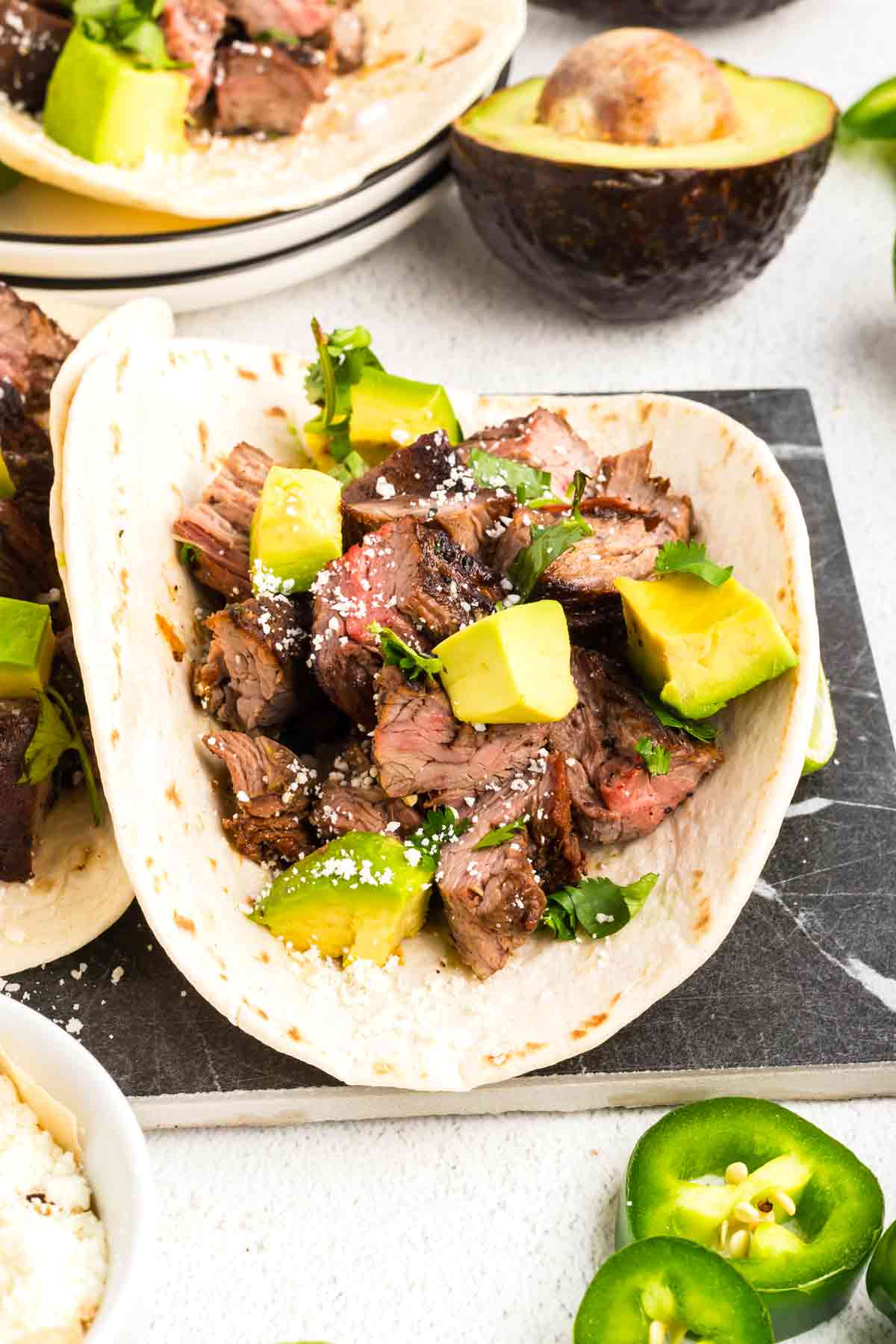 Carne Asada Tacos with avocado and cotija cheese