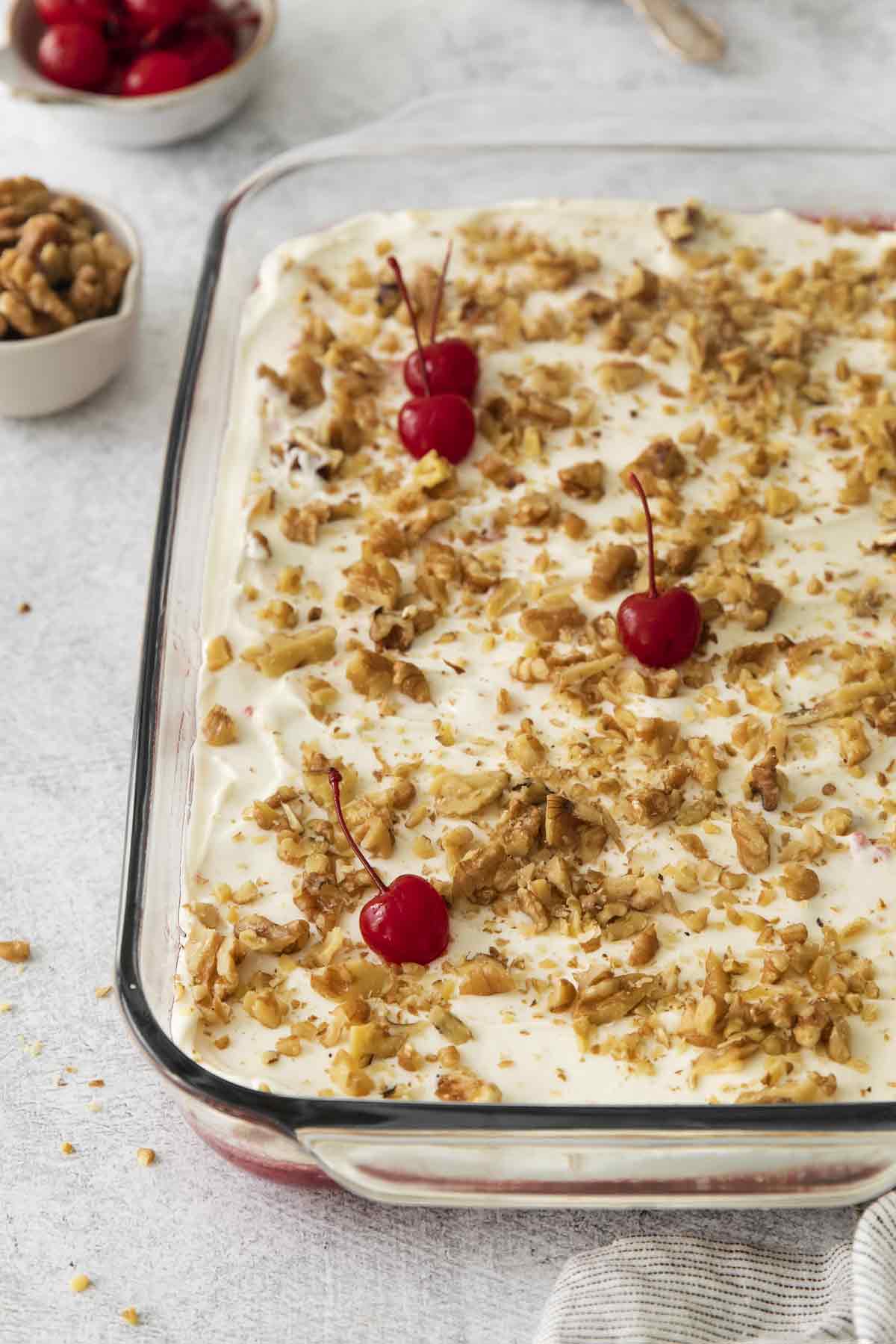 Pineapple and Cherry Jello Cream Cheese Dessert topped with nuts and granola