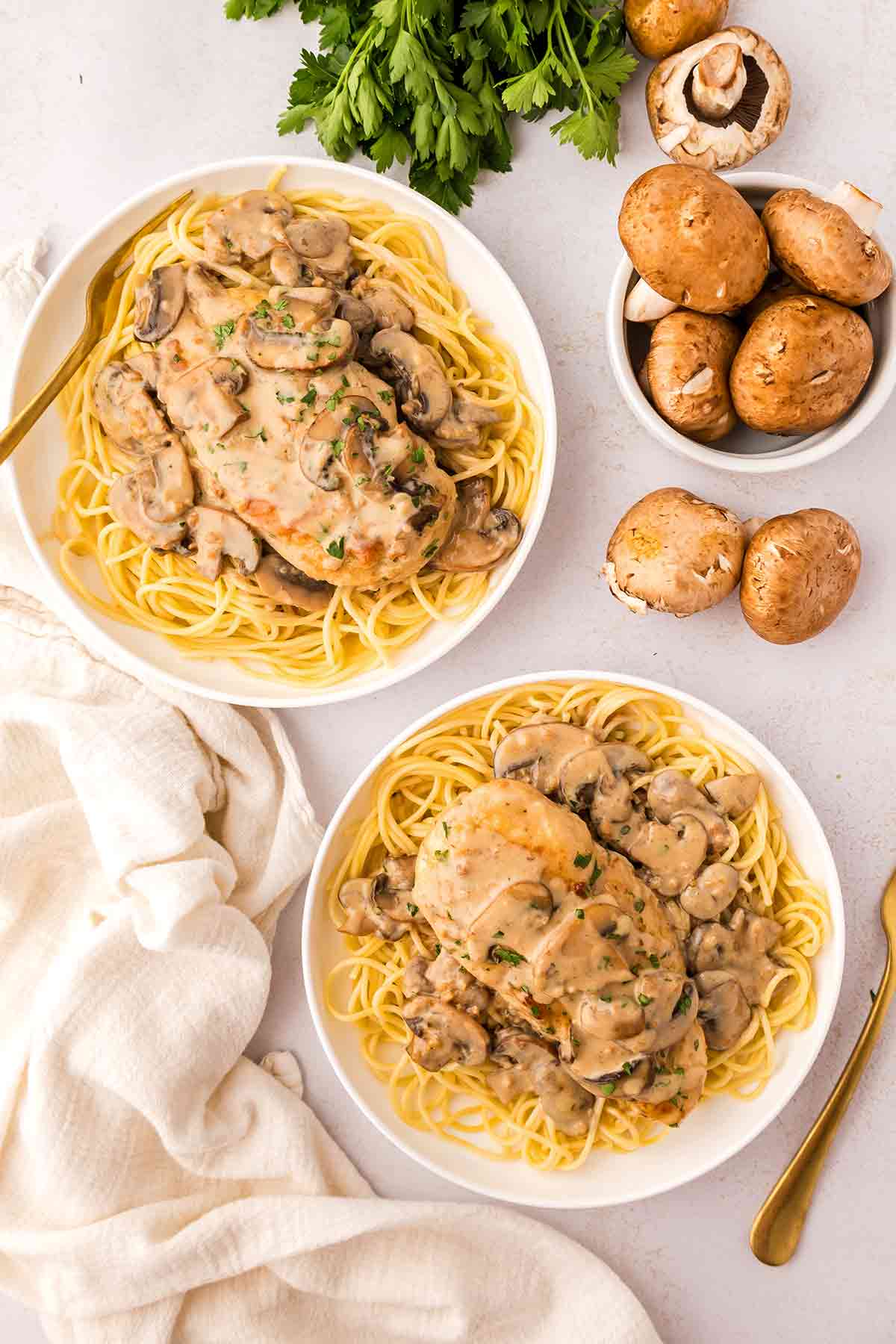 Chicken Marsala with mushrooms served over pasta