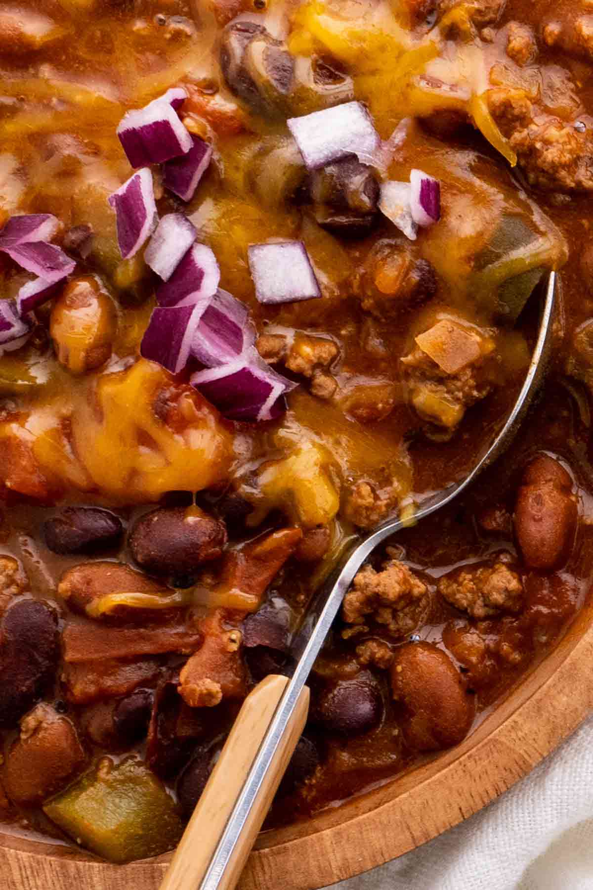 Chili with Beans, Peppers and Celery, topped with red onion and cheddar cheese