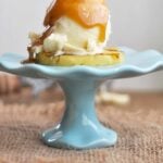 Grilled Pineapple with Ice Cream Rum Sauce Being Poured On Top