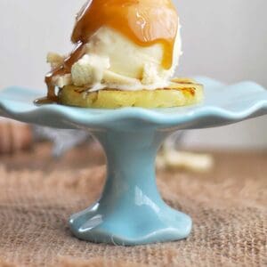Grilled Pineapple with Ice Cream Rum Sauce Being Poured On Top