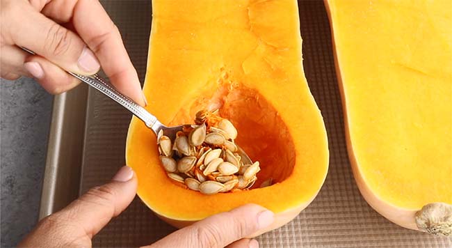Scoop out seeds from butternut squash