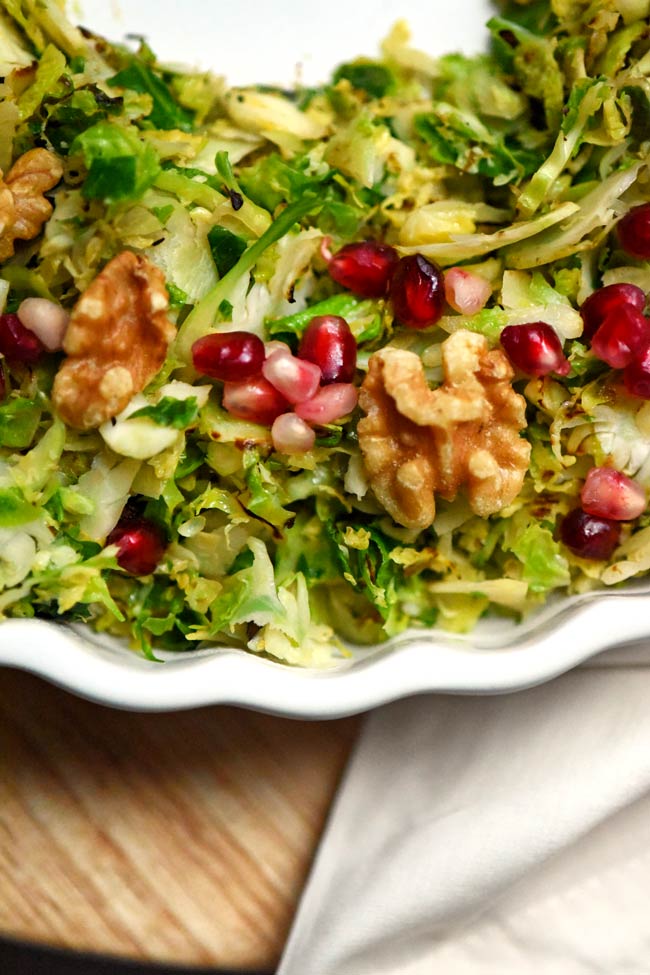 Shredded Brussels Sprouts with Pomegranate Seeds and Walnuts